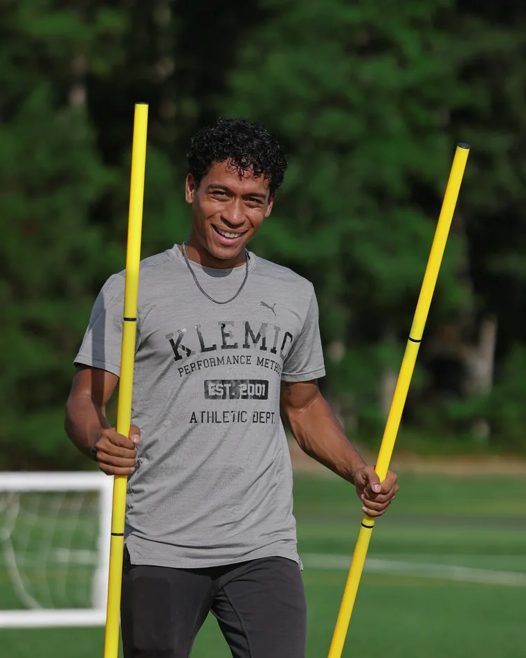 Cruz Lewis coaching on the field at KPM