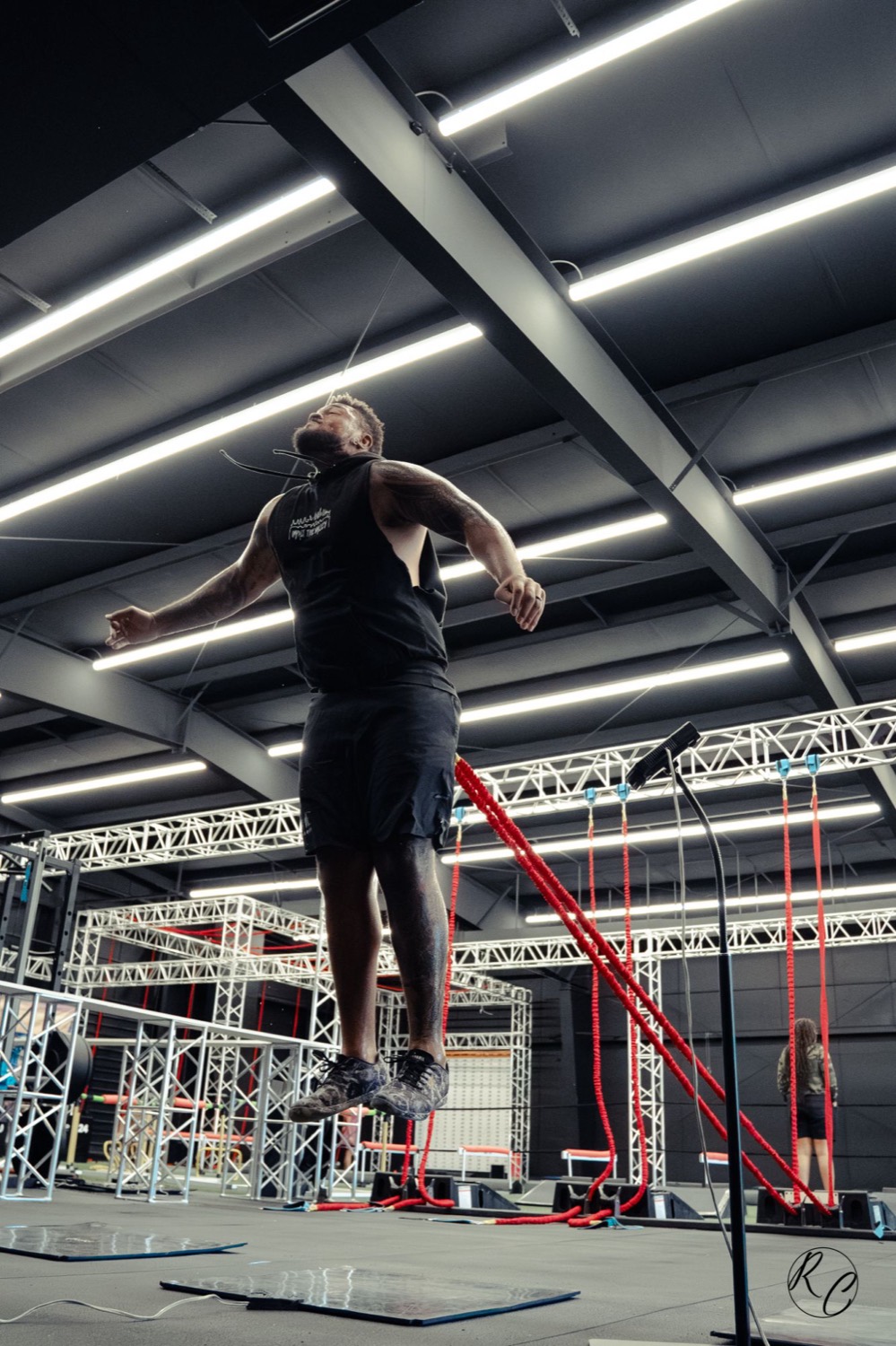 An athlete at the top of a jump, still loaded against the resistance cord