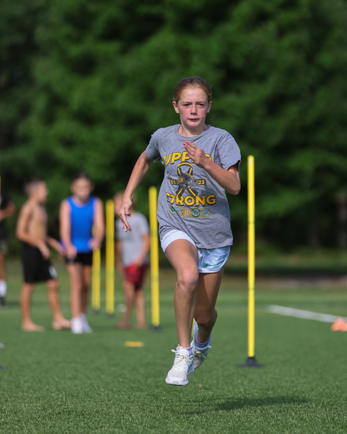 A New Athletes program athlete at full stride during a sprint