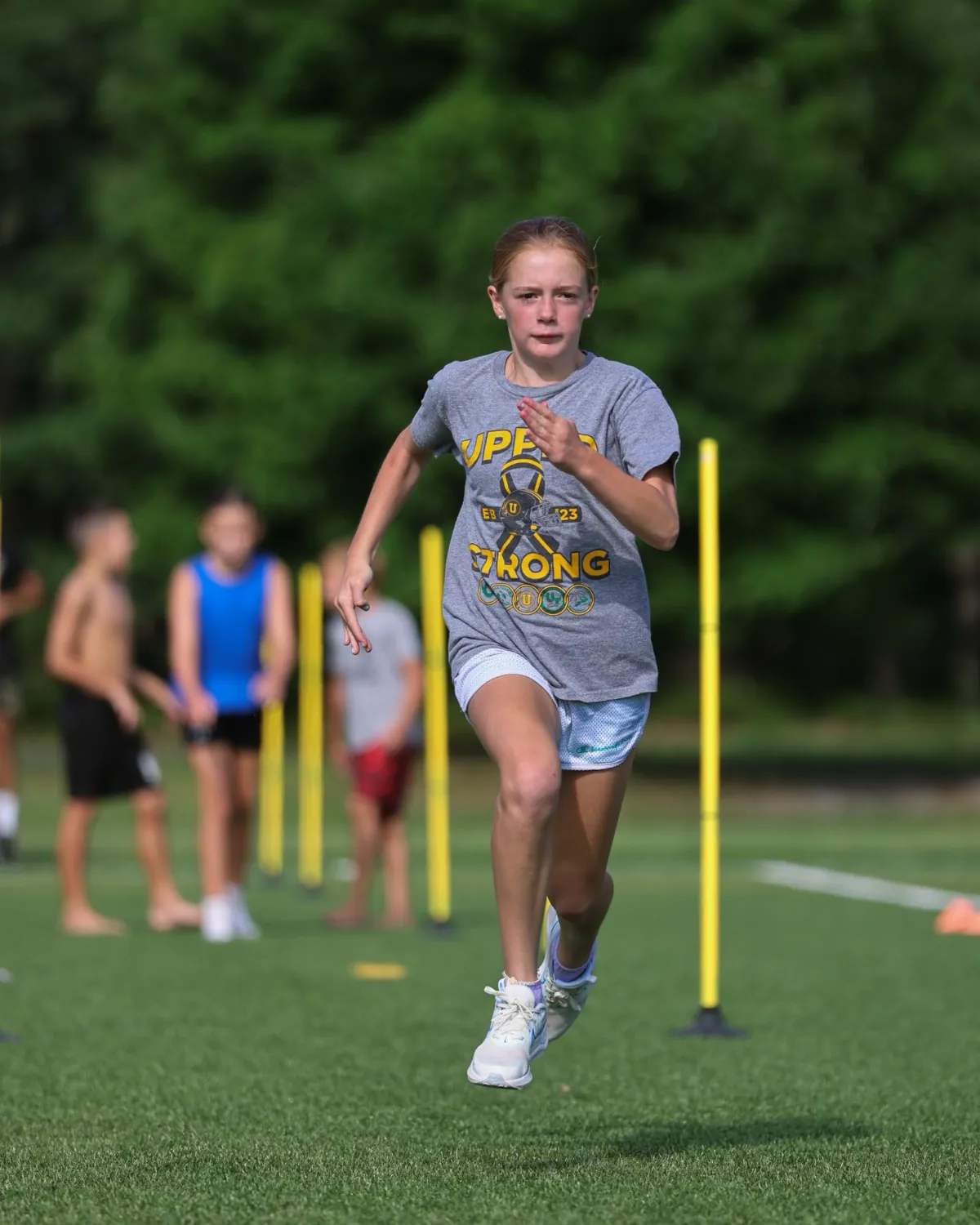 A New Athletes program athlete at full stride during a sprint