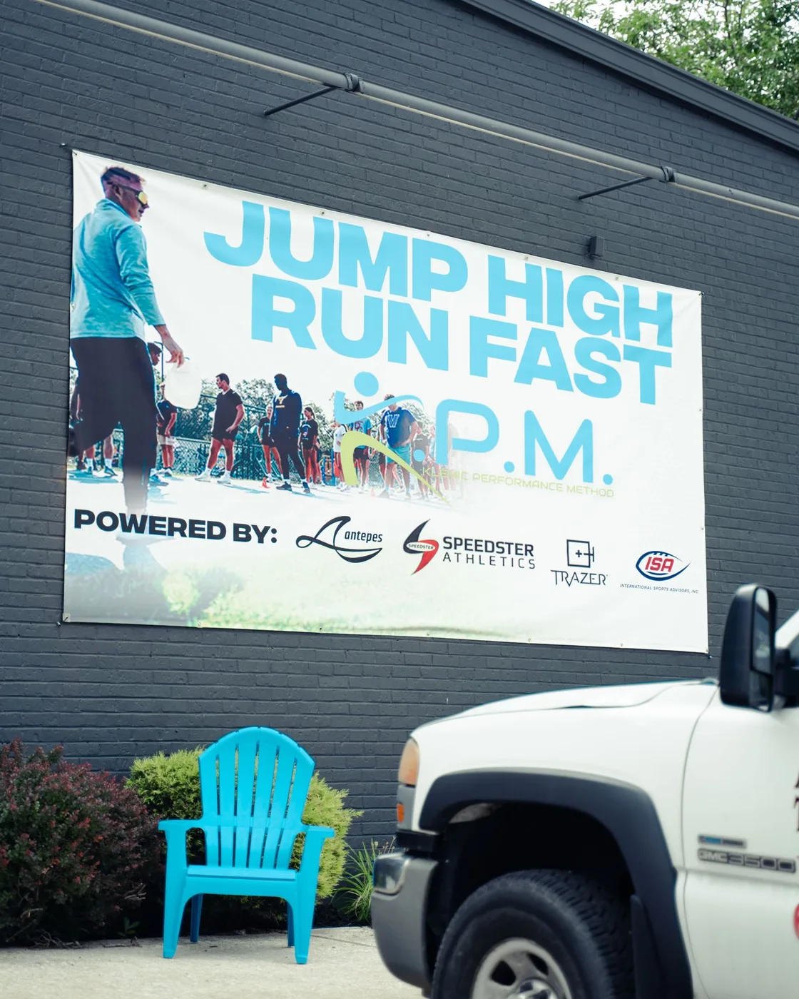 The Jump High Run Fast banner on the outside of the KPM building