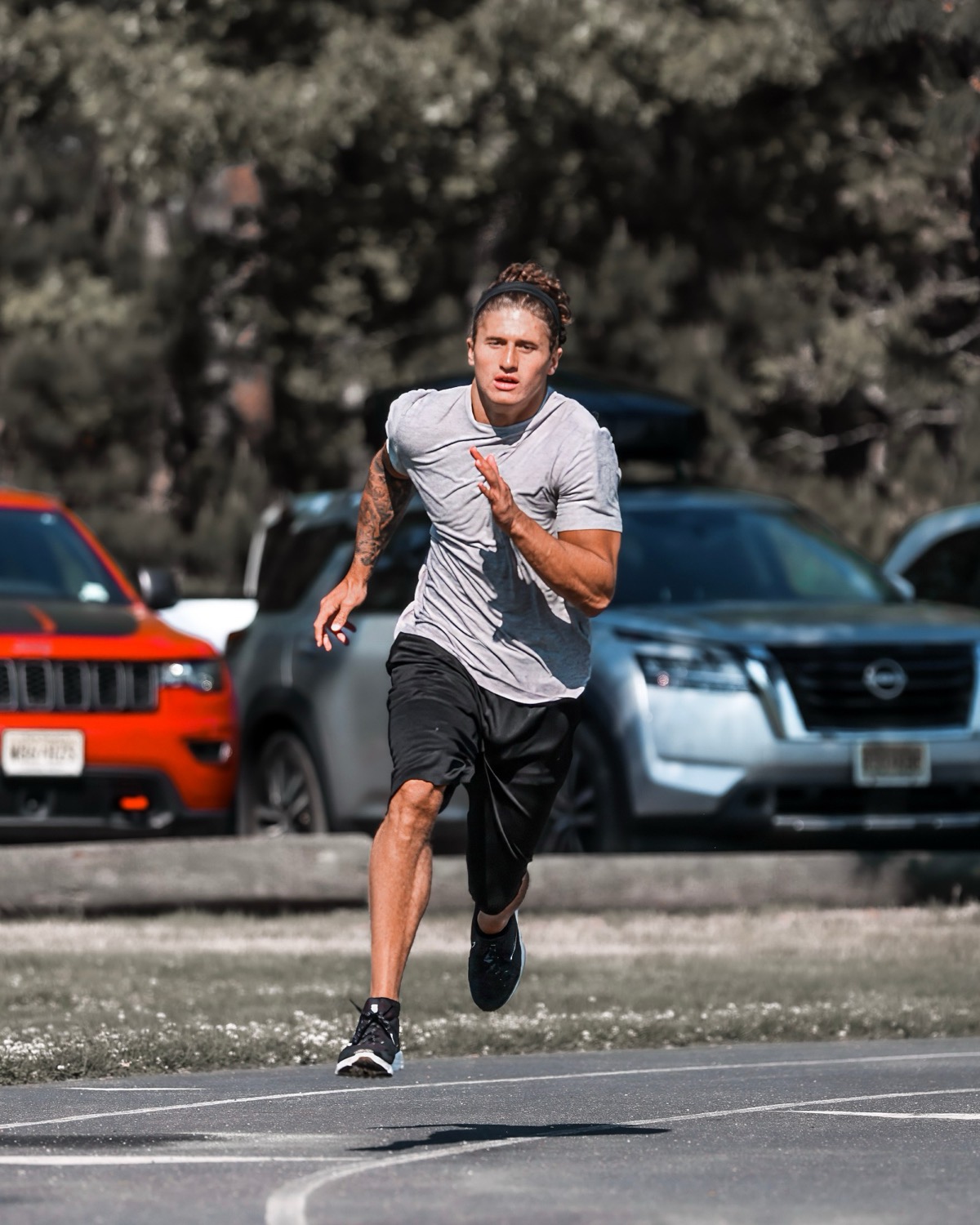 An athlete at full stride in an outdoor max-velocity run