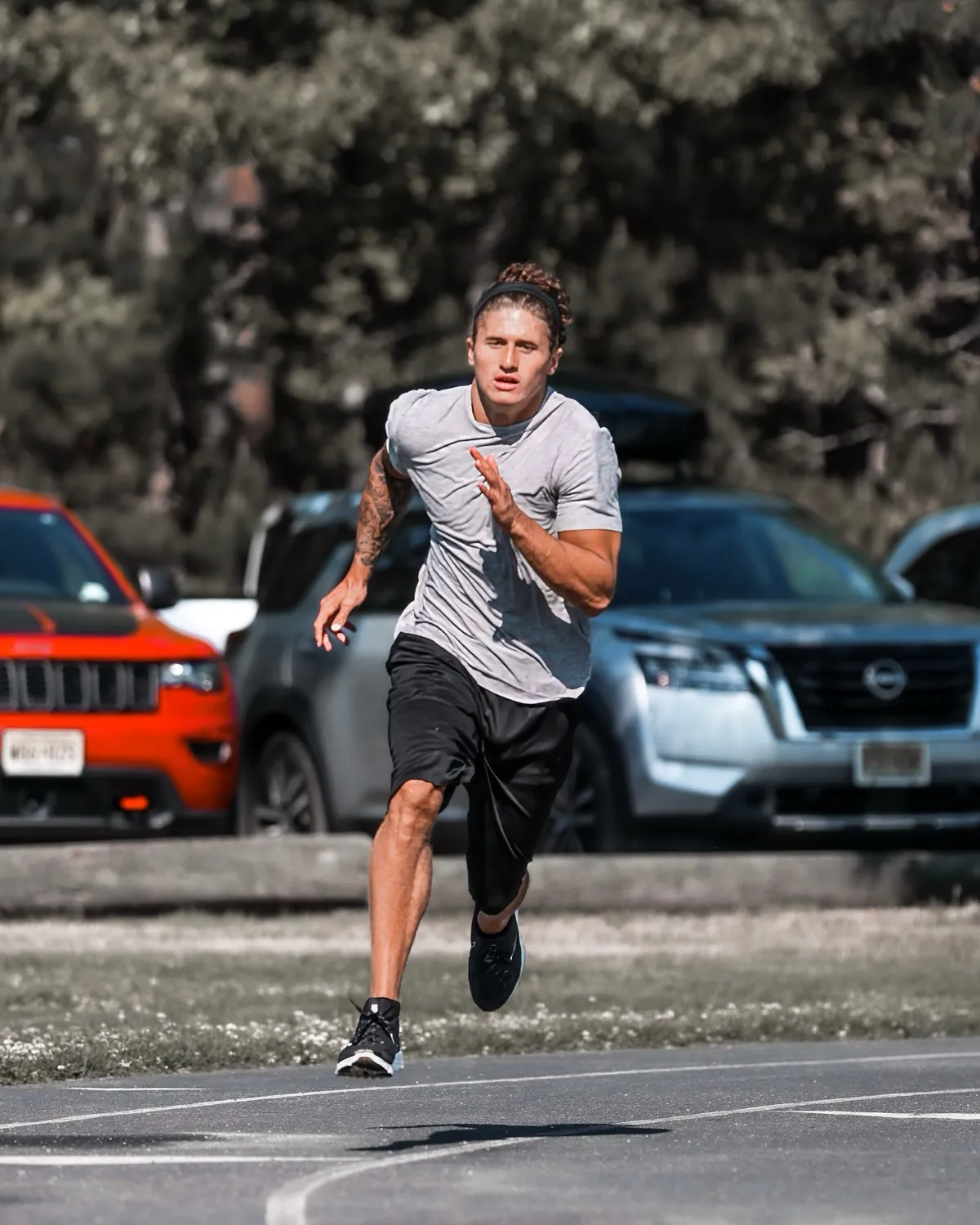 An athlete at full stride in an outdoor max-velocity run