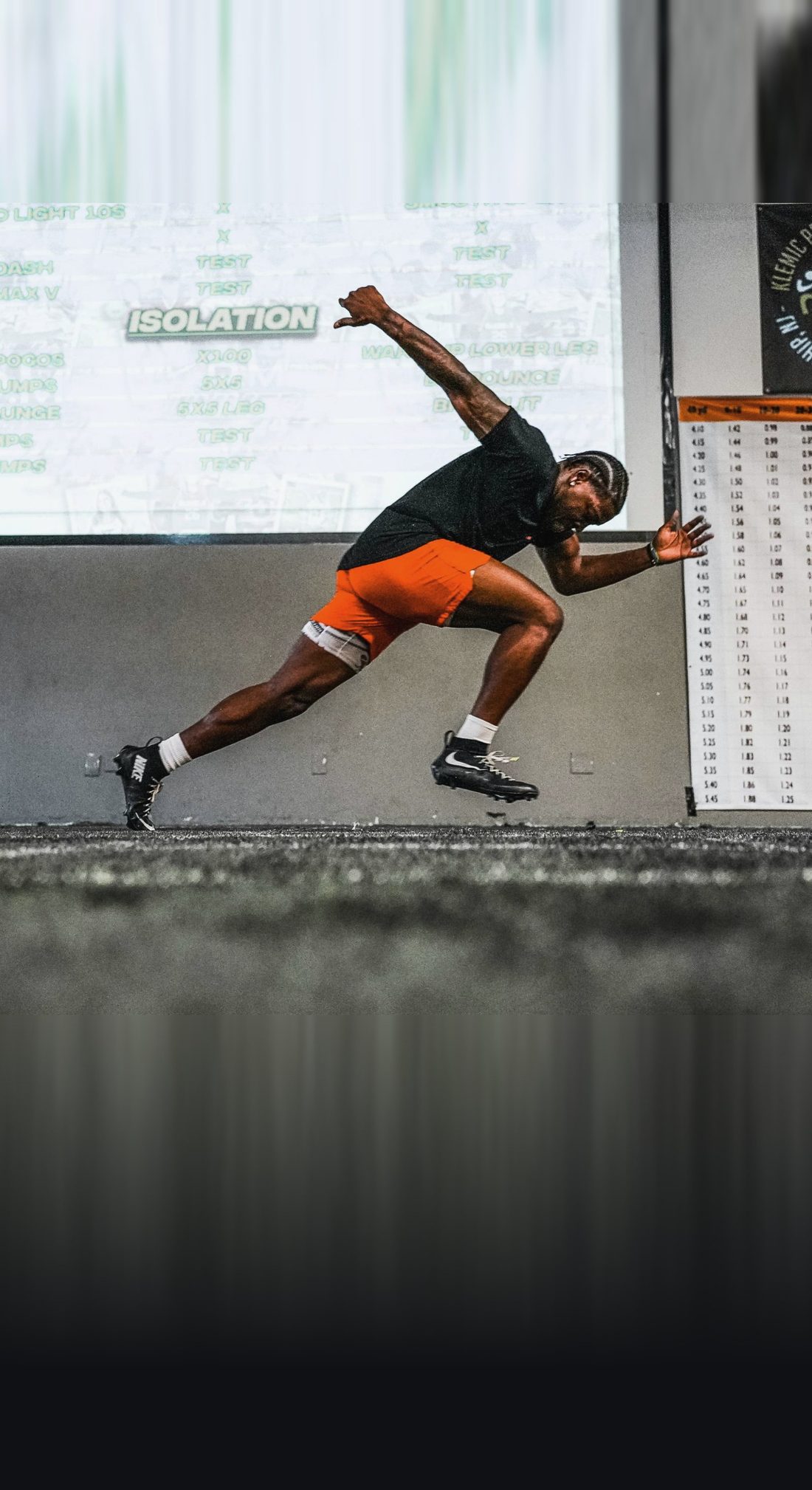 A KPM athlete driving out of a start in a deep forward lean