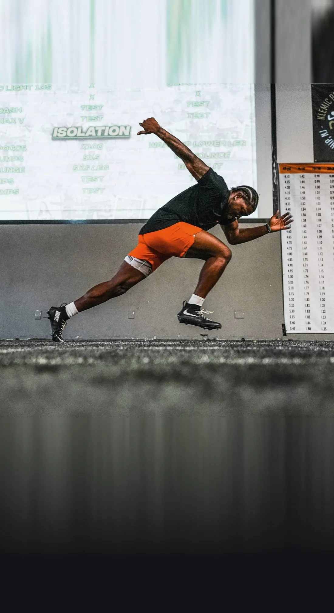 A KPM athlete driving out of a start in a deep forward lean