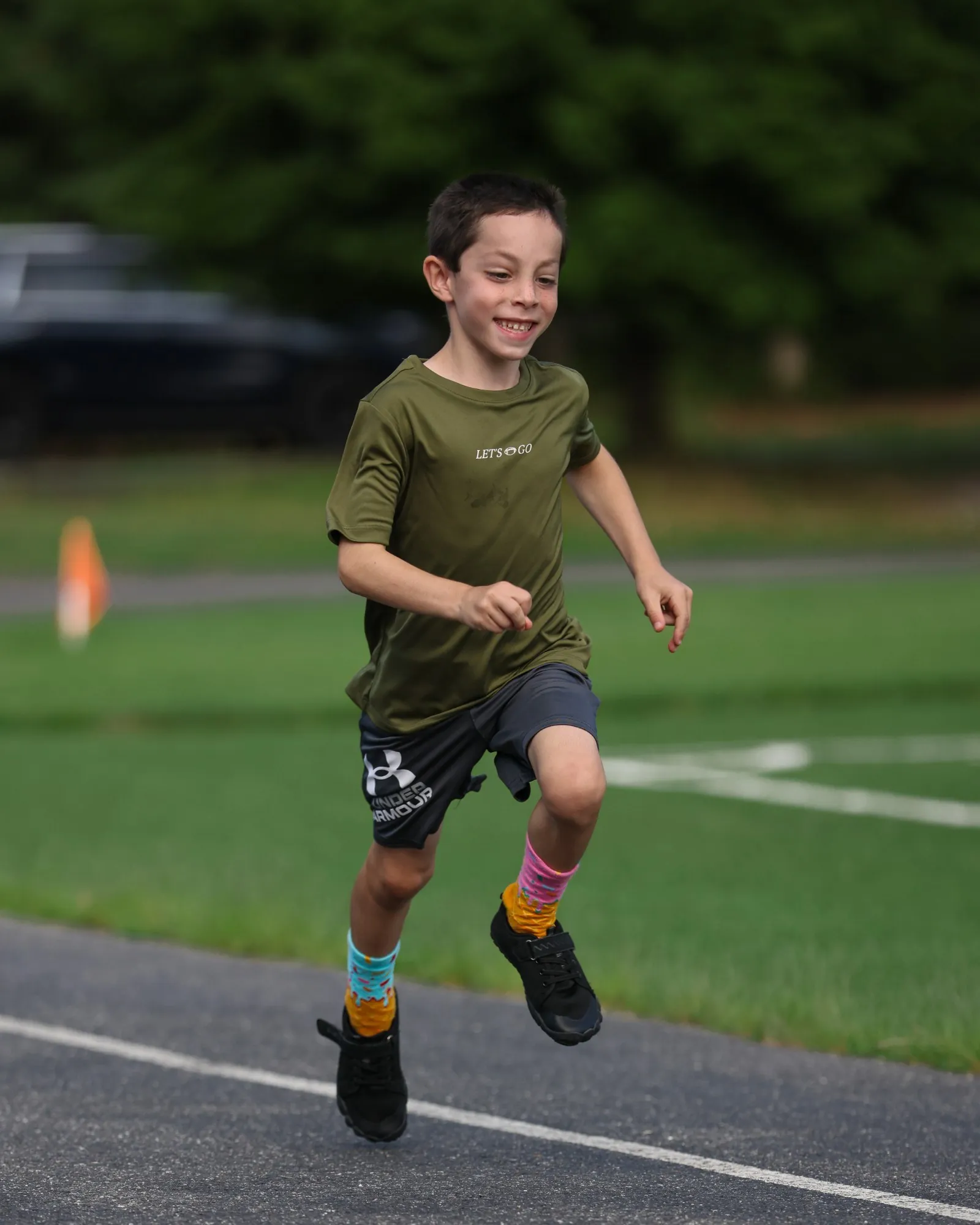 A Young Guns athlete running on the turf.